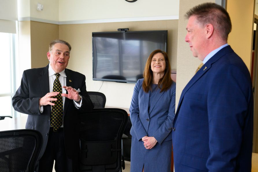 College of Law graduate and donor Rodney Windom (from left) catches up with Dean Amelia Smith Rinehart and son Scott Windom during a recent visit to campus. (WVU Photo/Matt Sunday)