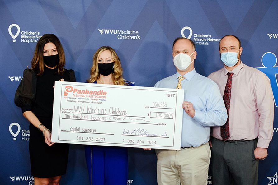 (From left to right) Amy L. Bush, R.N., M.S.N., M.B.A., chief operating officer for WVU Medicine Children's, and Marisa Sayre, marketing manager for WVU Medicine Children's, accept a $100,000 donation from Bob and Josh Contraguerro from Panhandle Cleaning