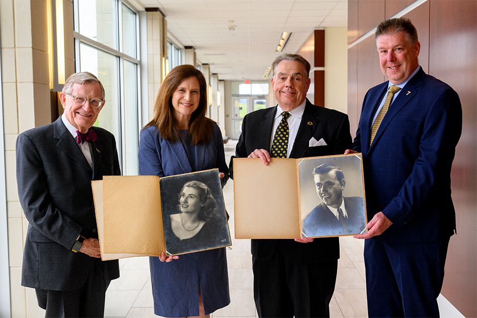 WVU President E. Gordon Gee (from left), College of Law Dean Amelia Smith Rinehart, Rodney Windom and Scott Windom celebrate the legacy of supporters Irene Moats Conaway (pictured in historical photos, from left) and Harry Moats. (WVU Photo/Matt Sunday