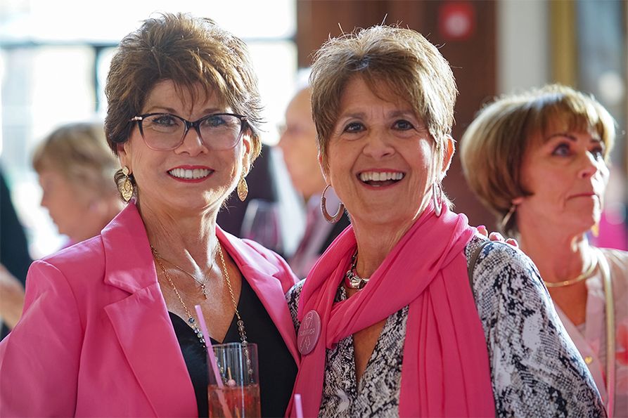 Attendees (from left) Mary Rose Giambrone and Vickie Lacy don their best blush attire for the Pink Party.