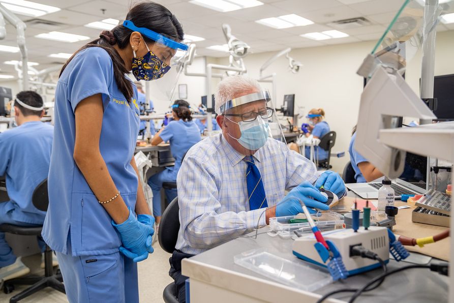3.	Dr. Bryan Dye (right) works with DDS student Payal Patel in the School’s simulation laboratory. A matching gift from Dye and his wife, Dr. Lora Graves, will aid patients in need and enhance educational opportunities for School of Dentistry students.