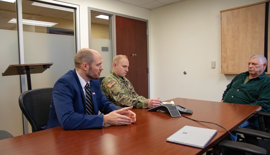 Veterans Advocacy Law Clinic Director Jed Nolan (left) and student attorney Mitch Duckworth (center) meet with veteran Lawrence Brown (right).