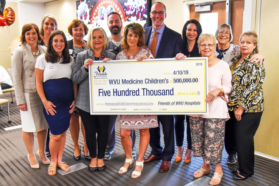 The Friends of WVU Hospitals Board of Directors presents a check for $500,000 to the WVU Medicine Children's 'Grow Children's' Capital Campaign.