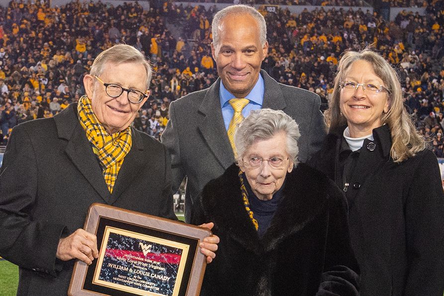 WVU President E. Gordon Gee presents the Most Loyal West Virginian award to Loulie Canady in 2018. College of Creative Arts Dean Keith Jackson and Kathy DeGraff stand behind her.
