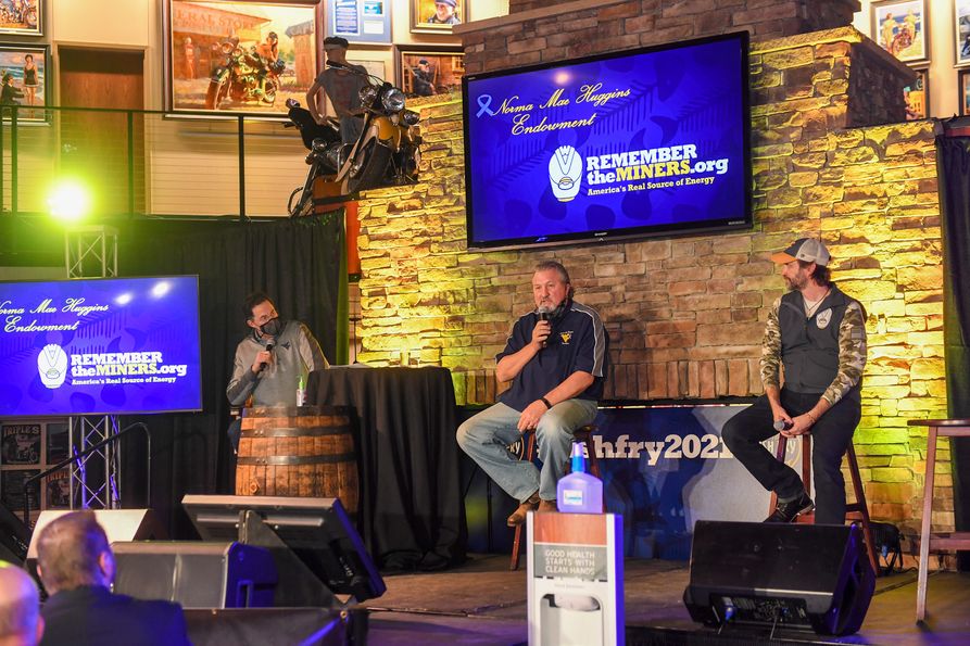 WVU Men’s Basketball Coach Bob Huggins (at center) speaks with (from left) emcee Tony Caridi and Remember the Miners co-founder Erik Muendel at the 2021 Fish Fry, streamed live Feb. 26 from Triple S Harley Davidson.